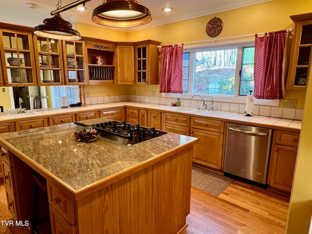 kitchen featuring a center island, stainless steel dishwasher, black gas stovetop, and ornamental molding