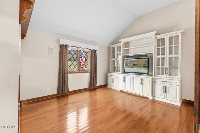 unfurnished living room with lofted ceiling and light hardwood / wood-style flooring