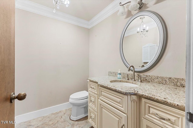 bathroom featuring vanity, an inviting chandelier, toilet, and ornamental molding