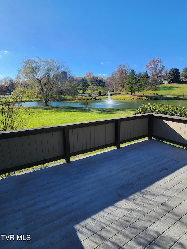 wooden terrace featuring a yard and a water view