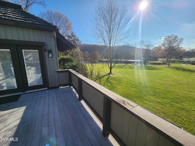 wooden deck featuring a yard