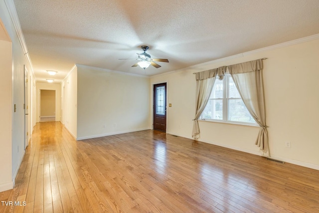 empty room with ceiling fan, crown molding, light wood-type flooring, and a textured ceiling