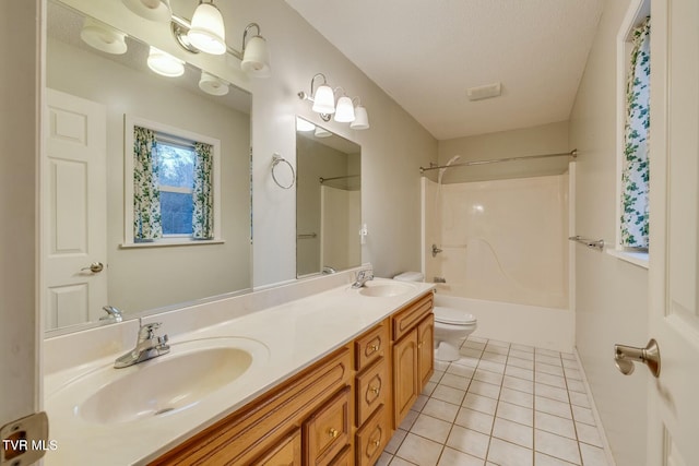 full bathroom featuring vanity, tile patterned floors, washtub / shower combination, toilet, and a textured ceiling