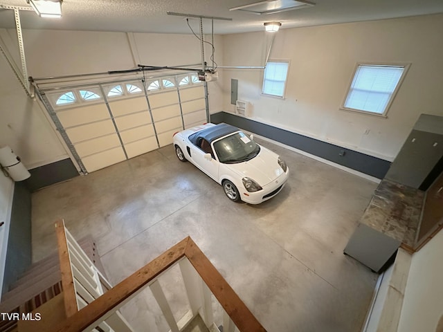 garage with electric panel and a garage door opener