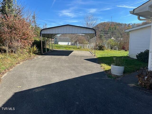 exterior space featuring a carport and a lawn