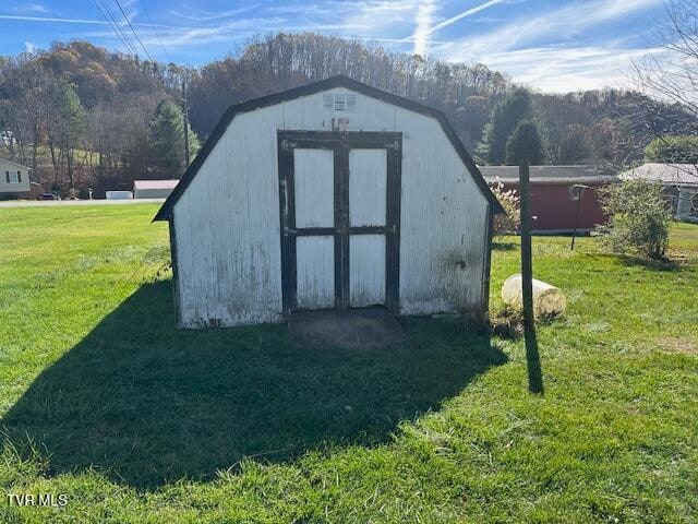 view of outbuilding with a lawn