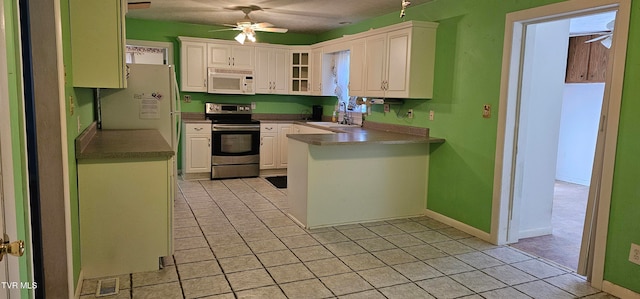 kitchen featuring white cabinetry, sink, ceiling fan, kitchen peninsula, and white appliances