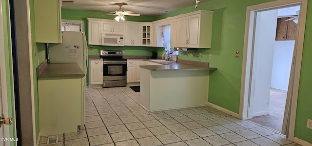 20286 Shadowood Cir, Meadowview, VA 24361 - kitchen featuring white appliances, ceiling fan, a peninsula, and light tile patterned floors
