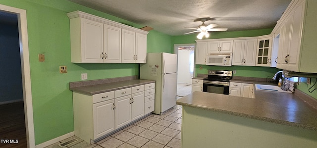 20286 Shadowood Cir, Meadowview, VA 24361 - kitchen featuring white appliances, a ceiling fan, white cabinets, glass insert cabinets, and a peninsula