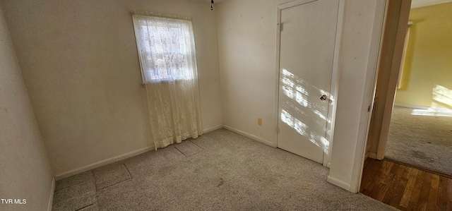 spare room featuring light carpet