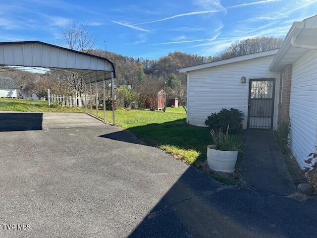 20286 Shadowood Cir, Meadowview, VA 24361 - view of green lawn with a detached carport