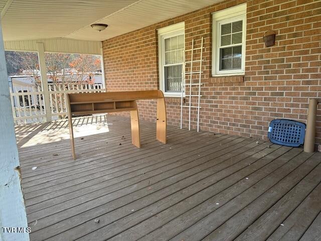 wooden terrace featuring covered porch