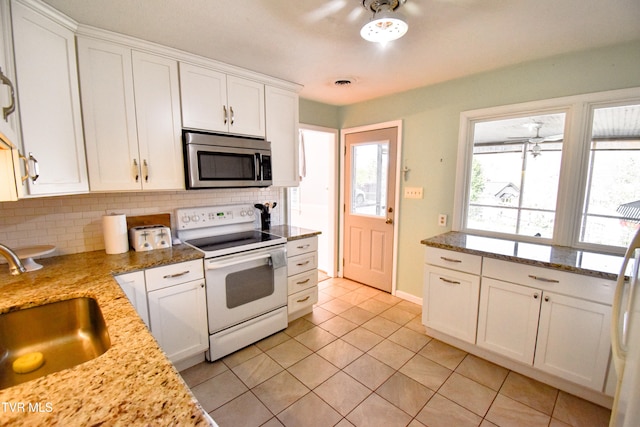 kitchen with white cabinetry, white range with electric cooktop, a healthy amount of sunlight, and sink