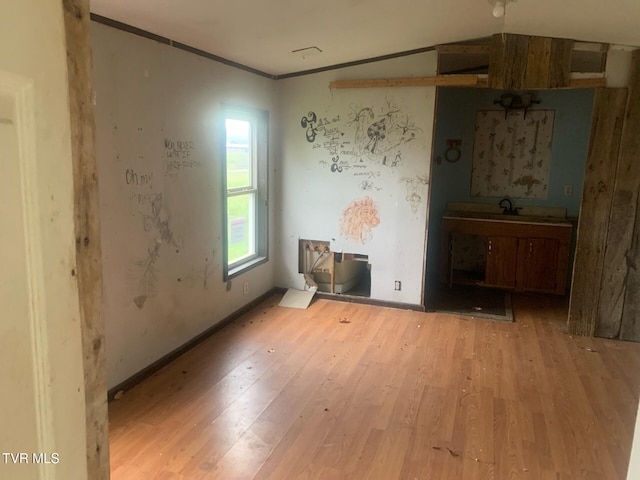 2260 Susong Memorial Rd, Greeneville, TN 37743 - unfurnished room with light hardwood / wood-style flooring, vaulted ceiling, crown molding, and sink