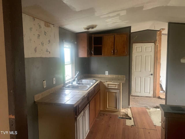 2260 Susong Memorial Rd, Greeneville, TN 37743 - kitchen with tile countertops, sink, lofted ceiling, and light wood-type flooring