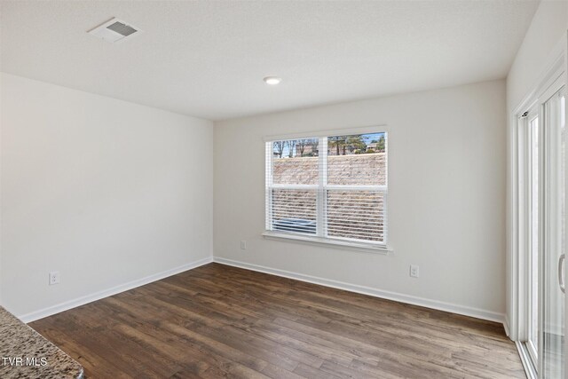 unfurnished bedroom featuring dark hardwood / wood-style flooring