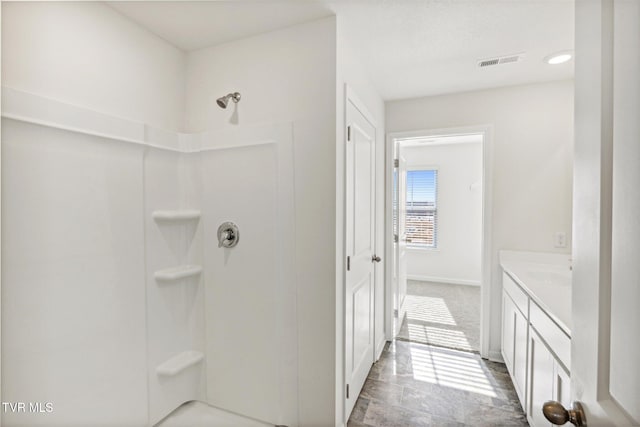 bathroom featuring vanity and a shower