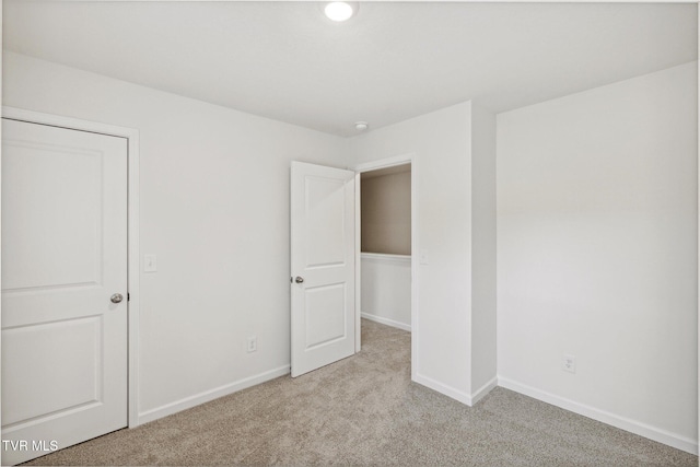 unfurnished bedroom featuring light colored carpet