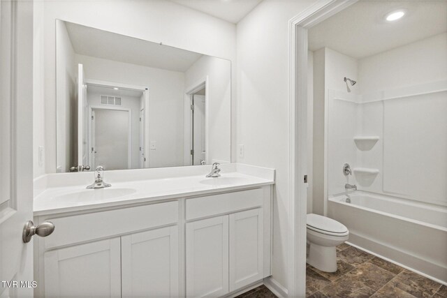 full bathroom featuring toilet, vanity, and bathing tub / shower combination