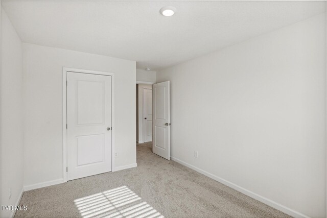 unfurnished bedroom with light colored carpet