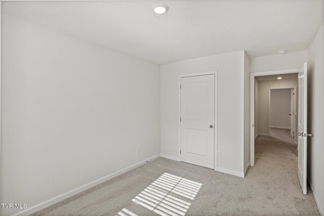 unfurnished bedroom with light carpet