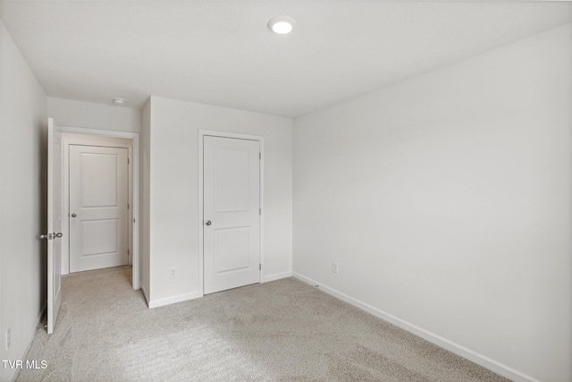 unfurnished bedroom featuring light carpet