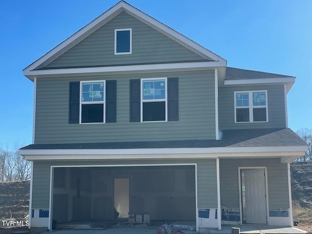 view of front of property with a porch and a garage