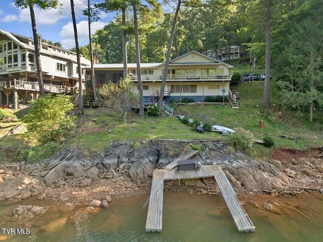 back of house featuring a water view