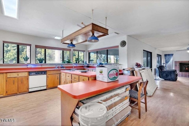 kitchen featuring white dishwasher, ceiling fan, and light hardwood / wood-style floors