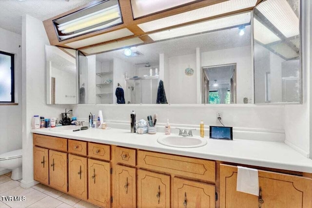 bathroom featuring walk in shower, a textured ceiling, vanity, tile patterned flooring, and toilet