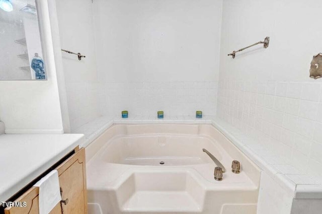 bathroom featuring a bathing tub and vanity