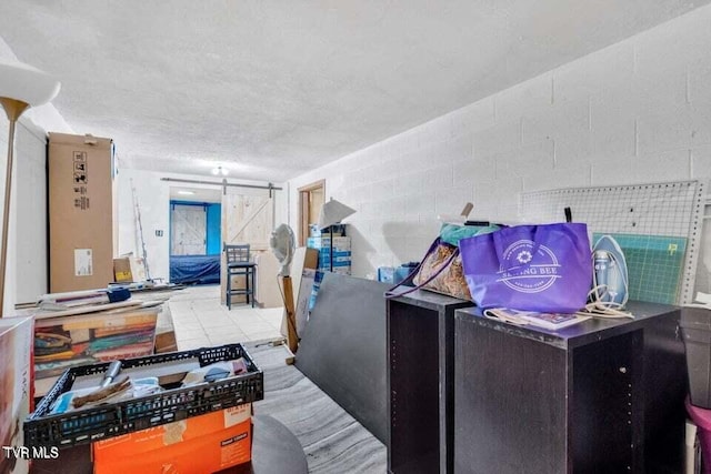 misc room featuring a barn door and a textured ceiling