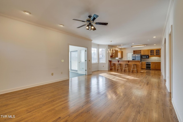 unfurnished living room featuring crown molding and light wood-type flooring