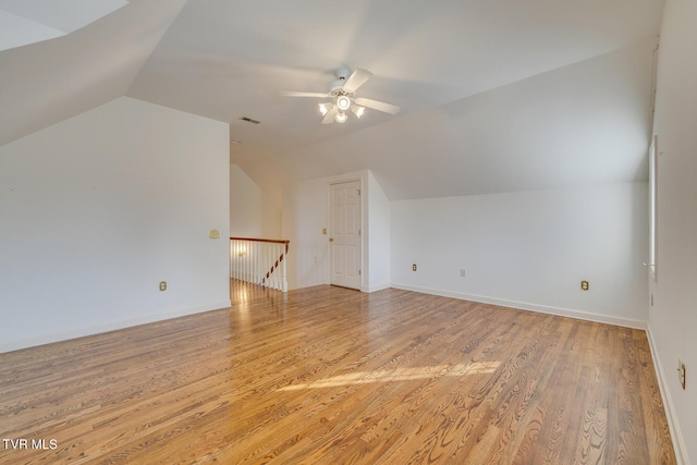 bonus room featuring ceiling fan, vaulted ceiling, and light wood-type flooring