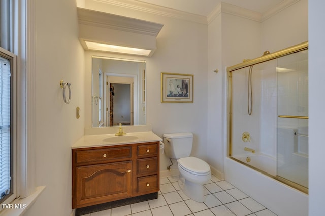 full bathroom with vanity, tile patterned floors, crown molding, bath / shower combo with glass door, and toilet