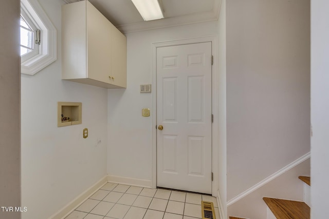 washroom featuring cabinets, light tile patterned floors, washer hookup, and ornamental molding