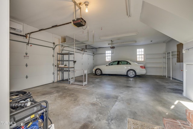 garage with a wall unit AC and a garage door opener