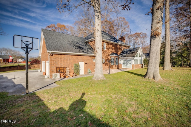 rear view of property with a lawn and a garage