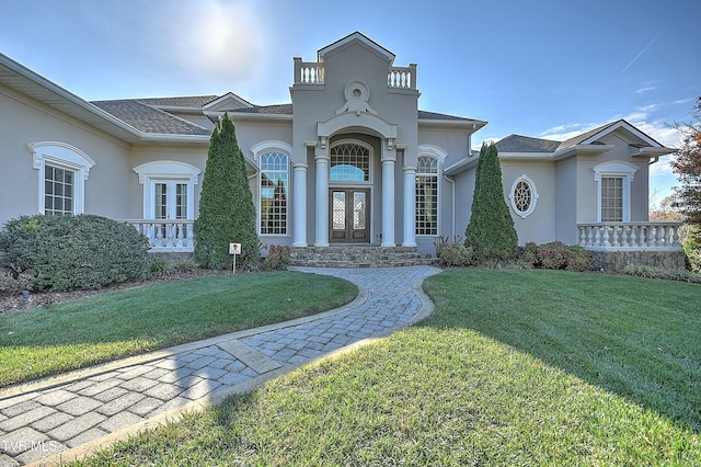 mediterranean / spanish house featuring french doors and a front yard