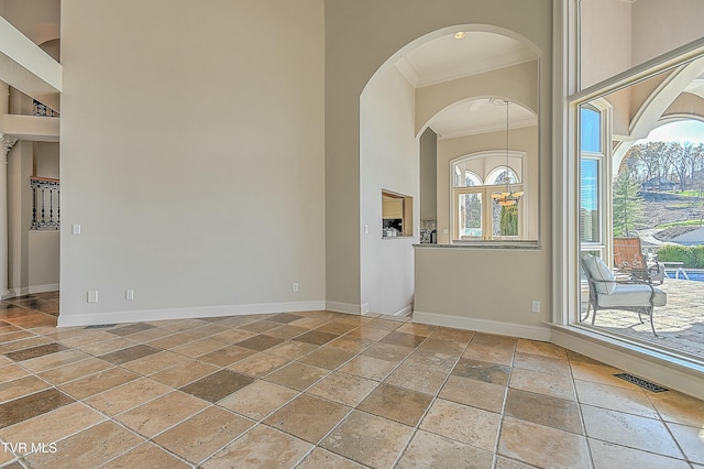 empty room featuring a healthy amount of sunlight and ornamental molding