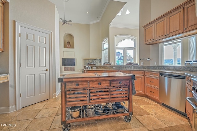 kitchen featuring ceiling fan, dishwasher, kitchen peninsula, dark stone counters, and ornamental molding