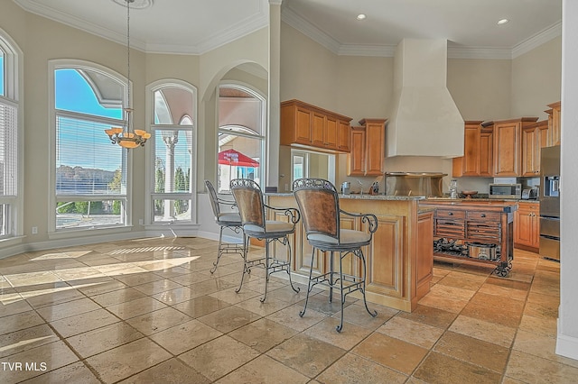 kitchen with crown molding, plenty of natural light, stainless steel appliances, and a notable chandelier