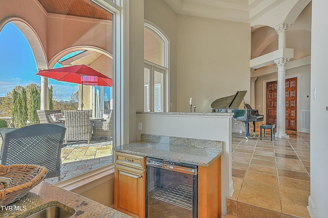 kitchen with decorative columns and beverage cooler