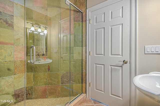 bathroom with sink, tile patterned flooring, and walk in shower