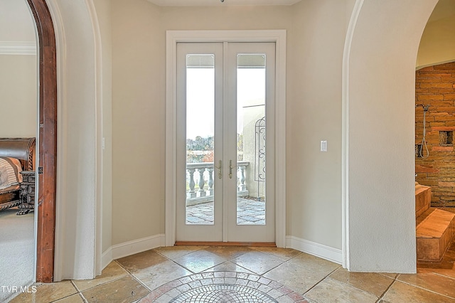 entryway featuring crown molding and french doors