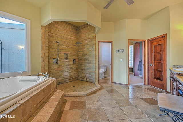 full bathroom with vanity, ceiling fan, separate shower and tub, toilet, and a towering ceiling