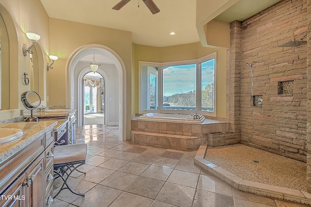 bathroom with vanity, ceiling fan, and shower with separate bathtub