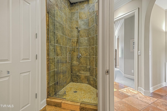 bathroom featuring ornamental molding and walk in shower