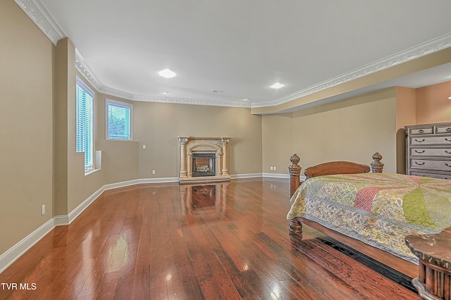 bedroom with crown molding and wood-type flooring