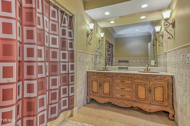 bathroom with vanity, tile walls, and ornamental molding